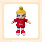 A plush soft toy depicting a Sikh boy with a patka (turban) in multicolor, wearing a red shirt and blue pants, made from soft fabric.