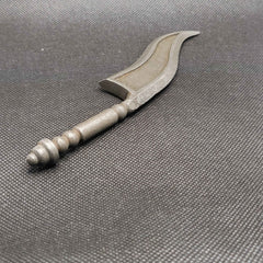 A metal toy sword with a silver finish and a decorative design on the blade, displayed against a textured dark background.